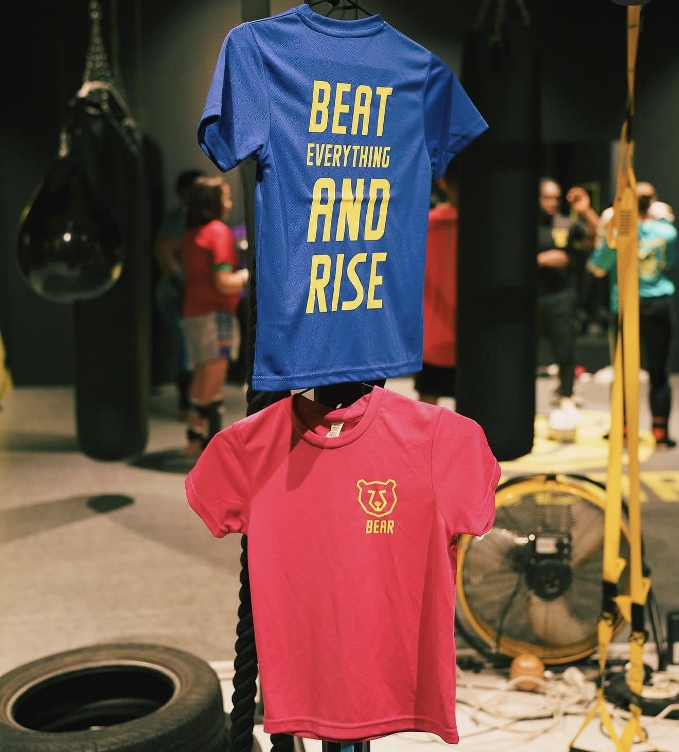 Two sports shirts on a rack in a boxing gym