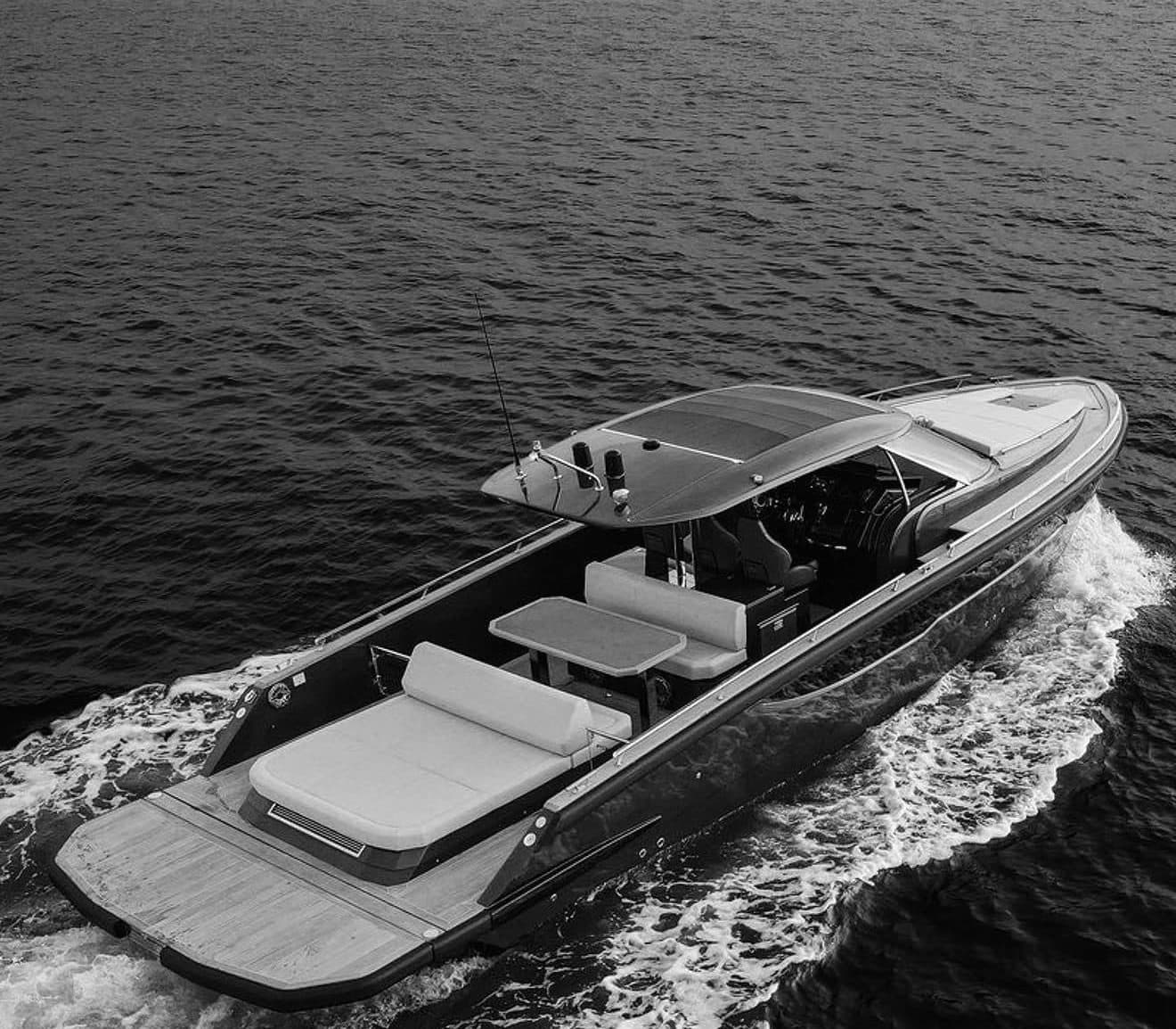 Black-and-white aerial shot of a motorboat on open water